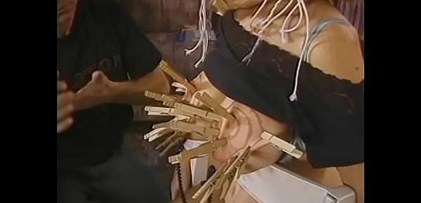  Two mature dudes bring a busty whore into the living room and hang clothespins on her intimate places